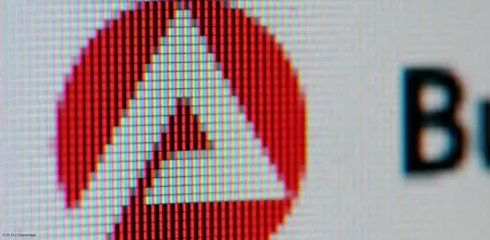 Das Logo der „Bundesagentur für Arbeit“ abfotografiert von einem Computerbildschirm (Detailaufnahme, sodass die einzelnen Bildpunkte des Monitors erkennbar sind).