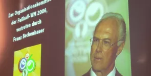 Franz Beckenbauer ist per Beamer-Bild an eine Landweind projeziert.