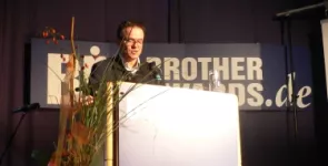 Moderator Andreas Liebold am Redner.innenpult.